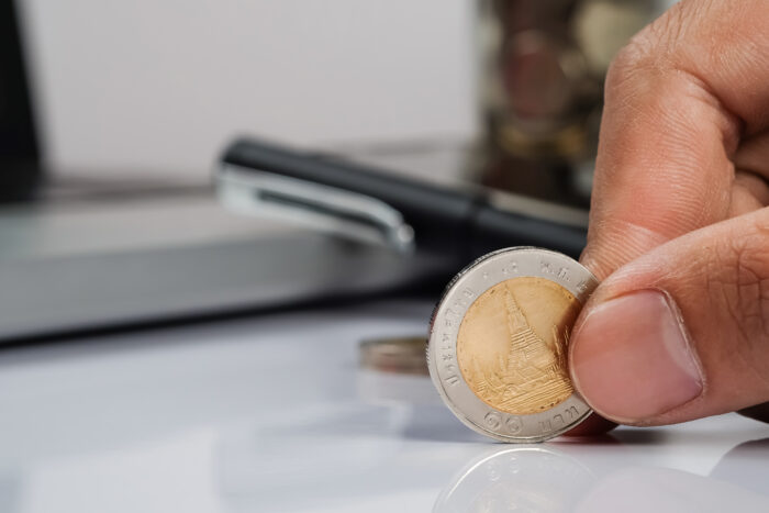 mao humana segurando uma moeda e espaco para copia conceito de plano de investimento empresarial 1