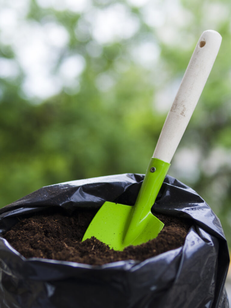 shovel inside soil bag
