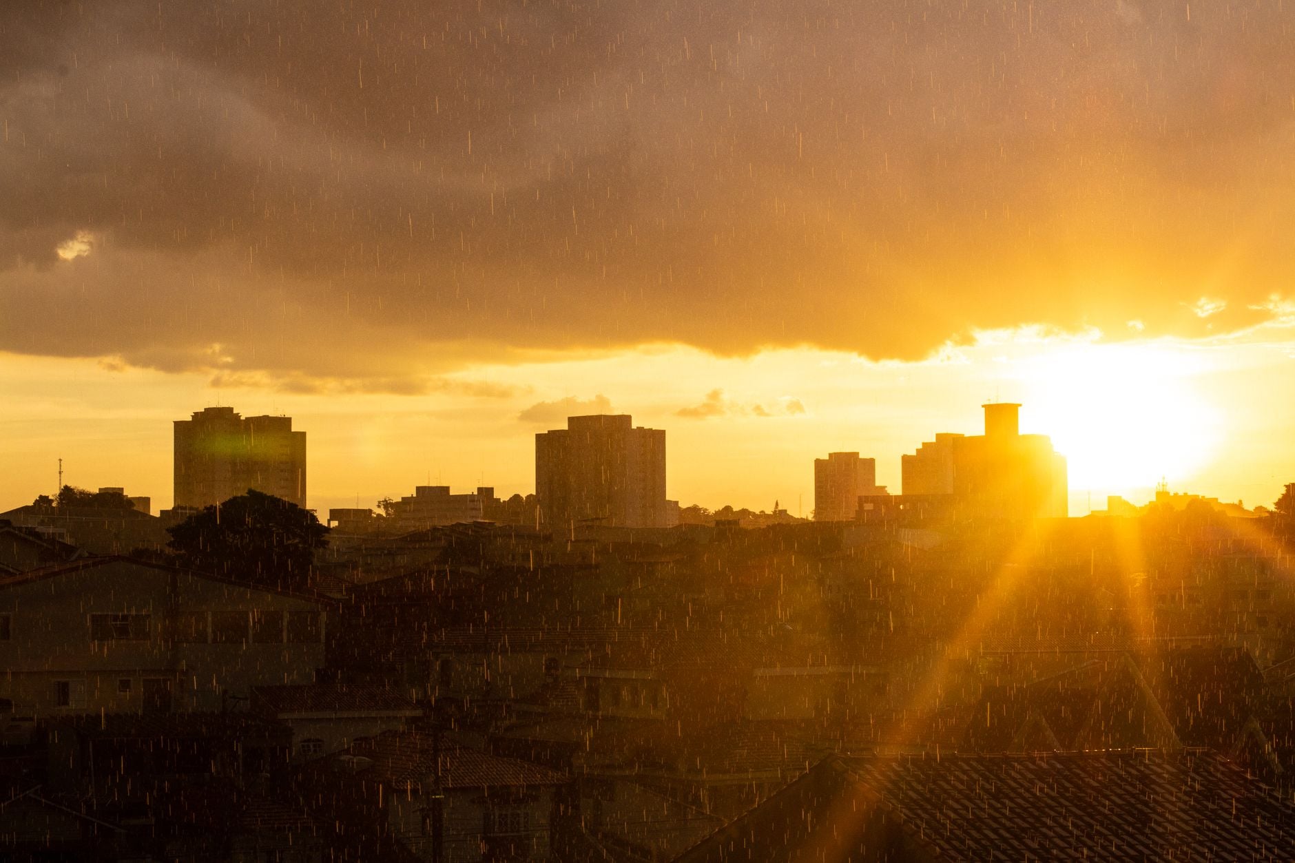 Próximo presidente do Brasil terá pela frente um problema que já afeta milhões de pessoas e pode se tornar ainda mais grave nos próximos anos 3 Silhueta do horizonte da cidade contra um radiante pôr do sol dourado, capturada durante a chuva.